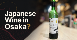 A bottle of Japanese wine (Nagano Black Queen) on the counter at Kaiebi, a 6-seat seafood restaurant in Osaka, with the text Japanese Wine in Osaka?
